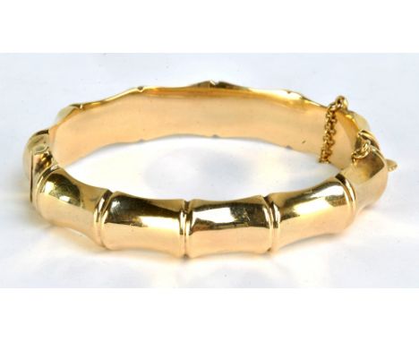 A 9ct yellow gold bamboo effect snap bangle, internal dimensions 5.8 x 5.2cm, approx 19.5g.
