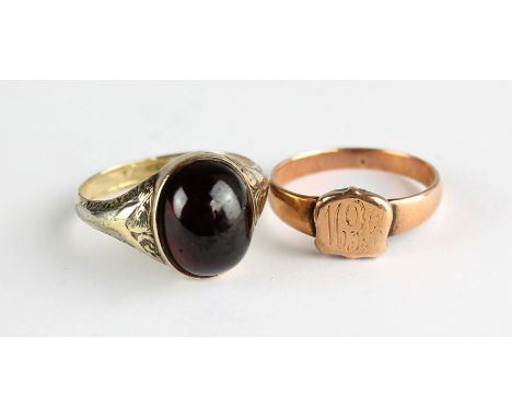 A 9ct yellow gold gentleman's ring set with oval garnet coloured cabochon, size P1/2 and an unmarked yellow metal signet ring