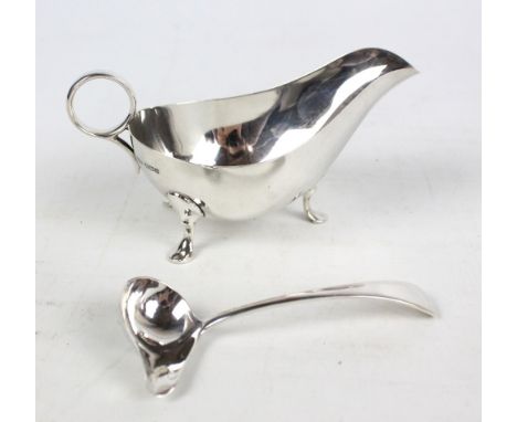 JAMES DIXON & SON; a George V hallmarked silver sauce boat of plain form with circular handle, length 16cm, and a matching Si