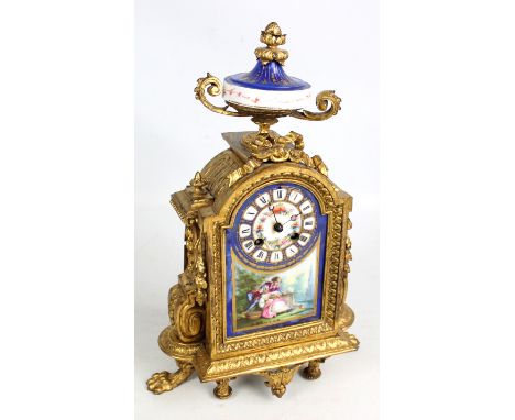 A late 19th century French gilt metal mantel clock with porcelain face set with circular chapter ring with Roman numerals abo