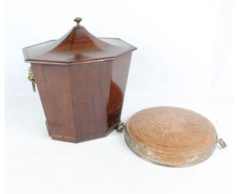 A Regency style mahogany oval faceted coal bucket with brass lion mask and ring handles, with detachable lid and with liner, 