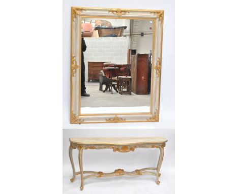 A contemporary cream and gilt serpentine outline console table, length 176cm and a similarly decorated rectangular wall mirro