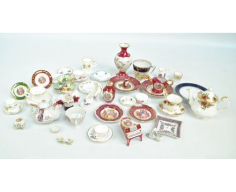 A collection of miniature ceramics including ornaments, plates, cups and saucers, jugs etc, including examples by Limoges, Vi