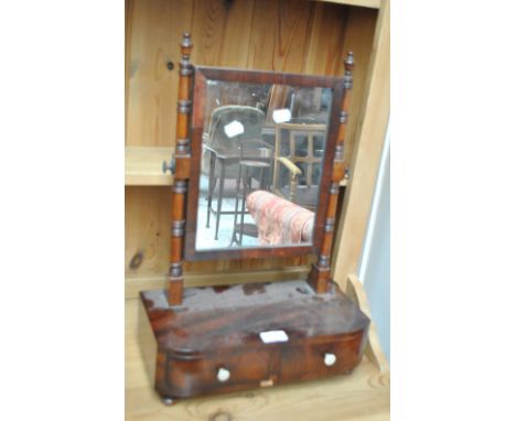 A 19th century mahogany swing frame toilet mirror with two drawers to the bow fronted base.