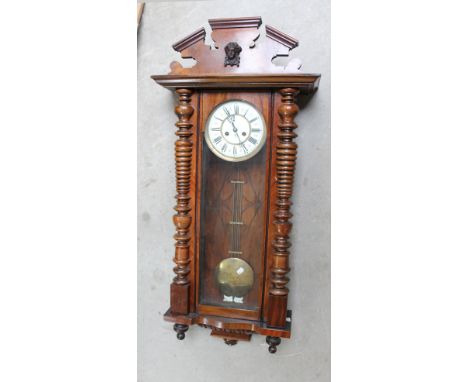A walnut cased Vienna style eight day wall clock, the white enamel dial style set with Roman numerals and inscribed GB, lengt