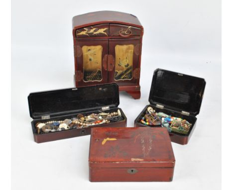 An early 20th century Japanese lacquered jewelry cabinet and three similarly decorated trinket boxes (4).