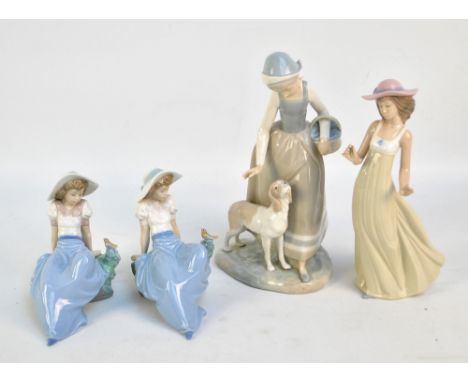 Four Nao figures; a large figure of a girl with a dog, two figures of a seated girl with a bird, and a further girl in a hat 