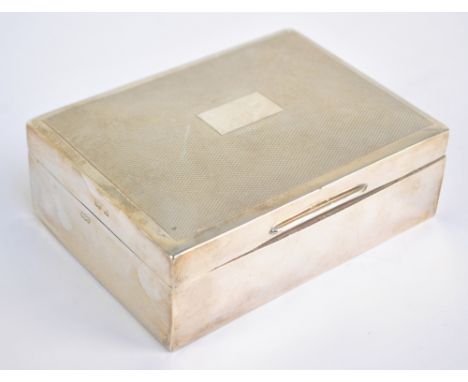 HENRY CLIFFORD DAVIS; an Elizabeth II hallmarked silver cigarette box, the engine turned decorated lid centred with vacant re