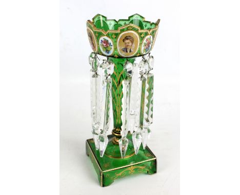 A 19th century Bohemian green glass table lustre with shaped gilt heightened rim, applied with four oval enamel plaques paint