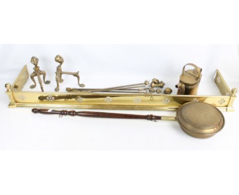 A group of brassware to include a watering can, a pair of andirons and a fender, width 139cm, also a floral embossed fire scr