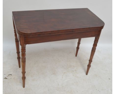 An Edwardian mahogany card table on tapering ring turned supports, width 91cm.