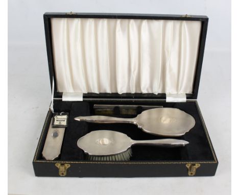 WI BROADWAY & CO; a cased Elizabeth II hallmarked silver dressing table set, comprising hand brush, length 24.5cm, mirror, co