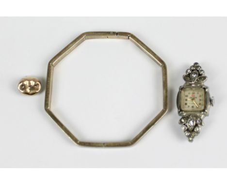 A Mexican 925 silver octagonal bangle, a stainless steel Art Deco style lady's wristwatch and a gold dental filling (3).