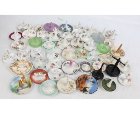 A collection of fifty-one ring trees, the majority being porcelain, also two ebony examples and three glass examples.