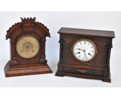 An early 20th century American oak striking mantel clock with architectural surround and embossed brass dial set with Arabic 