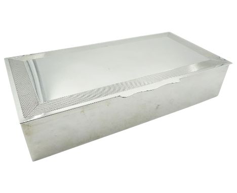 1920's silver mounted cigar box, of rectangular form, the hinged cover with engine turned border to edge, opening to reveal a