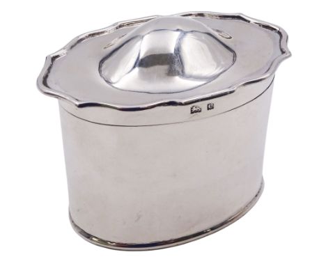 Edwardian silver tea caddy, of oval form, the hinged domed cover with shaped piecrust type rim, opening to reveal a gilt inte