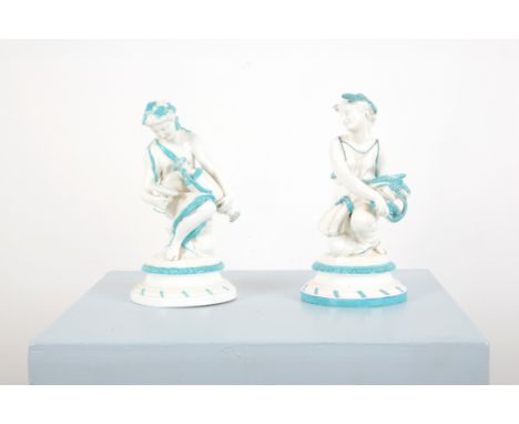 TWO CLASSICAL CERAMIC FEMALE FIGURESdecorated with a white and turquoise glaze, one of the figures holding a sheaf of wheat a