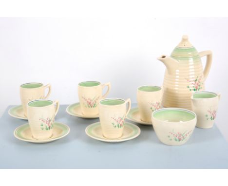 CLARICE CLIFF: A 'BIZARRE' WILD FLOWERS LYNTON COFFEE SERVICEthe ribbed ceramics decorated with pink flowers and foliage, com