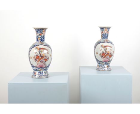 A PAIR OF CHINESE FAMILLE ROSE BALUSTER VASES decorated with two central cartouches, one containing a basket of flowers and t