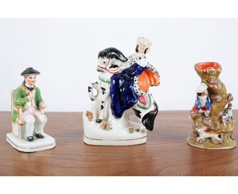 THREE STAFFORDSHIRE FIGURES including a figure of the young Victoria riding side-saddle on horseback, 18cm high, a spill vase