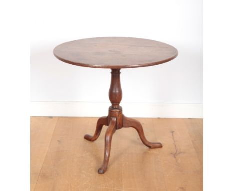 AN ENGLISH OAK TRIPOD TABLEon turned central column with cabriole legs and pad feet, 70cm high x 76cm diameter