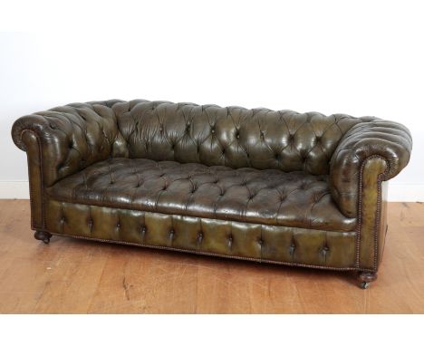 A GREEN LEATHER BUTTON-BACK CHESTERFIELD SOFAearly 20th century, with fixed upholstery secured by hobnails throughout, termin