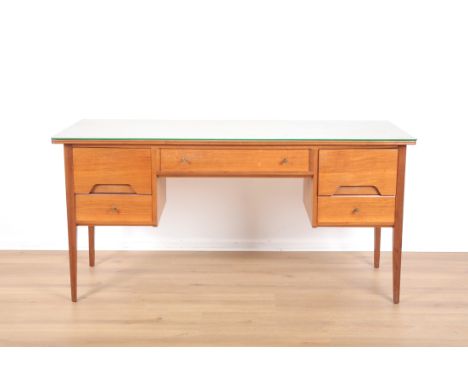 A. JOHN HERBERT BY A. YOUNGER LTD.: A TEAK DESK OR DRESSING TABLE mid-century modern, the front of bow-front outline, black l