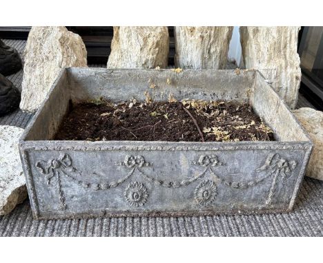 A RECTANGULAR LEAD PLANTERdecorated in relief with festoons and floral motifs, 22cm high x 60cm wide x 42cm deep; together wi