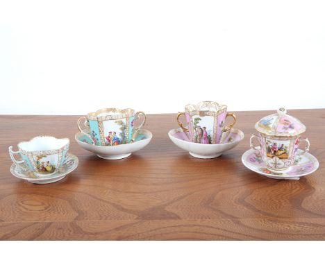 A GROUP OF FOUR DRESDEN CABINET CUPS 18th/19th century, the cups with figural cartouches surmounted by gilt borders and flora