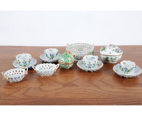 A GROUP OF FOUR ENCRUSTED DRESDEN CABINET CUPS the surface with polychrome forget-me-nots, foliage, and fauna, three with an 