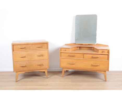 G PLAN: AN OAK DRESSING TABLEwith inbuilt swing mirror, the shaped top with a small drawer to either side, above two small dr
