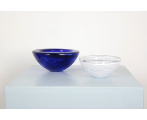 TWO KOSTA BODA CIRCULAR GLASS BOWLSone clear with swirling milky inclusions, 17.5cm diameter, the other of marbled cobalt blu