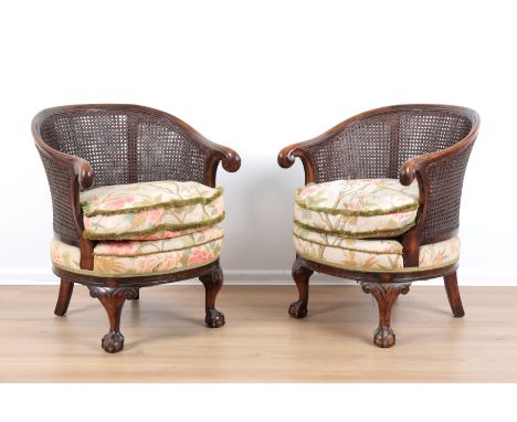TWO MAHOGANY DOUBLE-CANE TUB CHAIRS late 19th/early 20th century, each with removable shaped seat cushion, scrolled down swep
