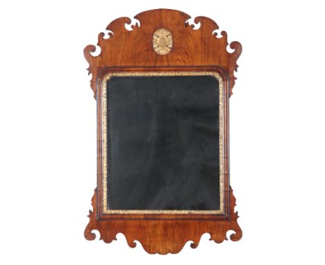 A GEORGE II STYLE MAHOGANY MIRROR with shaped cresting board and inset giltwood floral patera, the glass plate set within a g