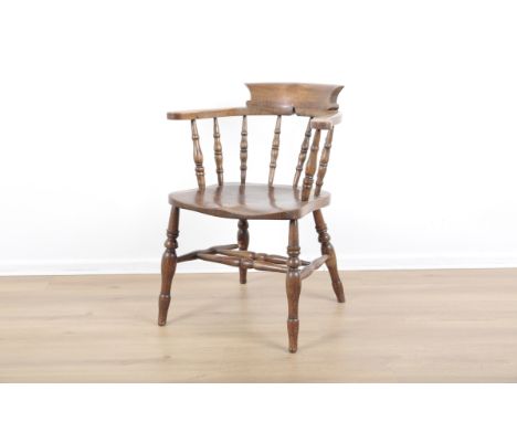 AN ELM AND ASH CAPTAIN'S CHAIR19th/20th century, the shaped back on turned supports with a saddle seat, 80cm high x 65cm wide