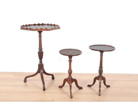 THREE MAHOGANY TRIPOD TABLES 20th century and later, two with pie crust edges and one with inlaid satinwood patera, the talle
