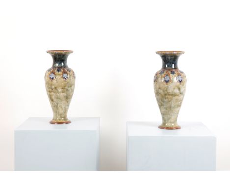 ROYAL DOULTON: A PAIR OF LARGE STONEWARE ART NOUVEAU VASEScirca 1895, of baluster form with raised flowerheads and leafy tend