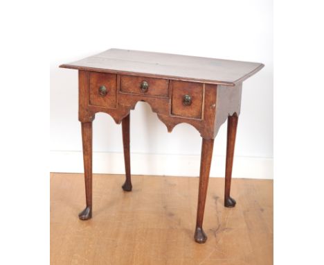AN OAK LOWBOYearly 18th century, of diminutive proportions, with two plank top and two deep drawers flanking a shallow centra