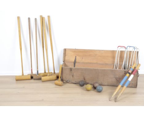 A CROQUET SETcomprising six mallets, a small wooden hammer, six hoops, two goal sticks, and four balls, 30cm high x 114cm wid