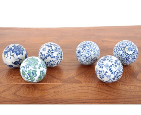 A COLLECTION OF SPHERICAL CERAMIC CARPET WEIGHTS OR DECORATIVE ORBS with various floral and geometric patterns, approx. 8cm d