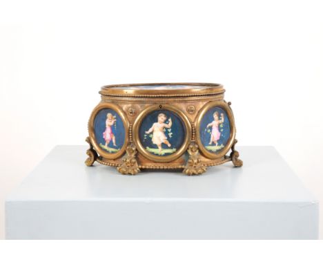 A GILT-METAL FRAMED OVAL CASKET WITH PORCELAIN VIGNETTES French, 19th century, the blue ground oval panels containing cavorti