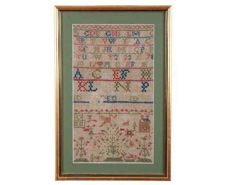 A VICTORIAN SAMPLER embroidered mostly in cross stitch with alphabet worked to the top and with house, fruiting trees and sta