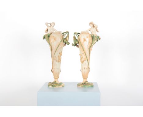 EDUARD STELLMACHER (GERMAN, 1868-1929) FOR AMPHORA POTTERY CO.: A PAIR OF ART NOUVEAU OR JUNGENSTIL NYMPH VASES the maidens e