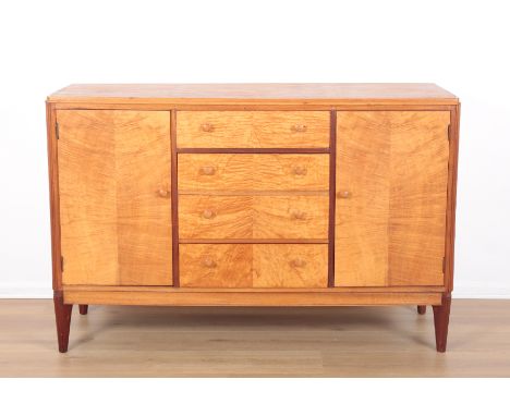 BEITHCRAFT: A BURR MAPLE SIDEBOARDScottish, mid-century modern, with a door to each side opening to internal shelving, and a 