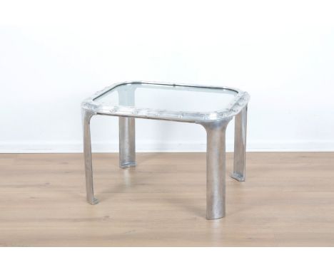 AN ALUMINIUM SHIP'S PORTHOLE CONVERTED TO A SIDE TABLE rectangular, terminating on curved legs, 47.5cm high x 72cm long x 57c