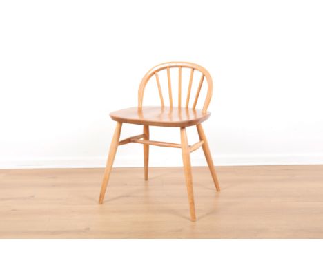 ERCOL, MODEL NO. 414: A BEECH AND ELM LOW-BACKED DESK OR DRESSING TABLE CHAIR1960, with hoop back over shaped seat and tapere