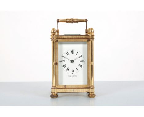 MAPPIN & WEBB LTD.: A BRASS CARRIAGE CLOCKthe top with acorn finials, with bevelled glass facets, the white enamel dial with 