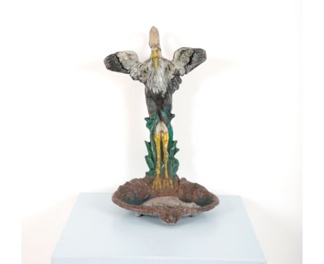 A VICTORIAN PAINTED CAST IRON STICK STANDin the form of a heron with outstretched wings, the drip tray in the form of a pond 