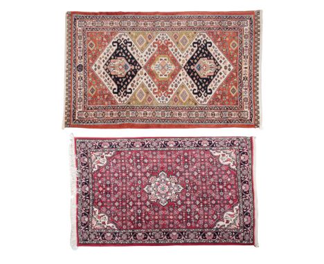 A PERSIAN RUG OF KASHAN DESIGNwoven in pink and other colours with double headed rose medallion and floral filler motifs on a
